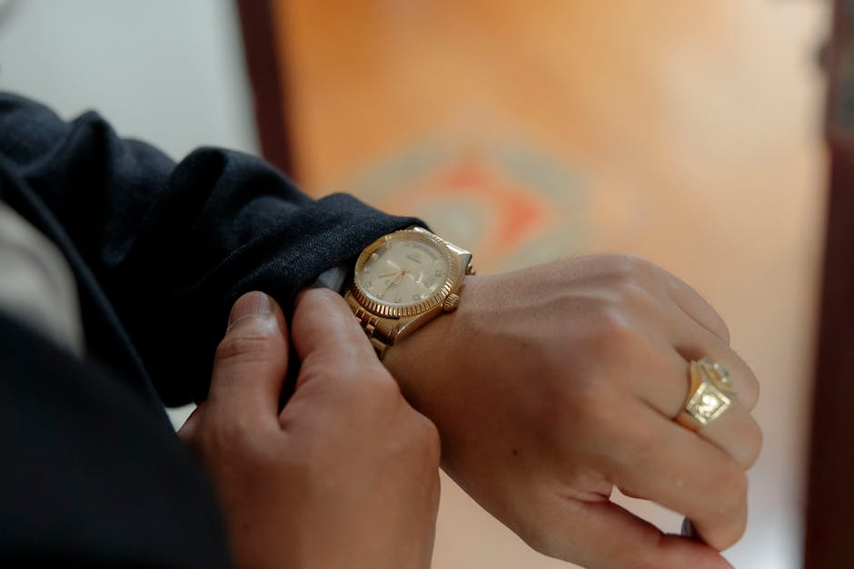 Close-up of elegant gold watch on wrist, expensive accessories