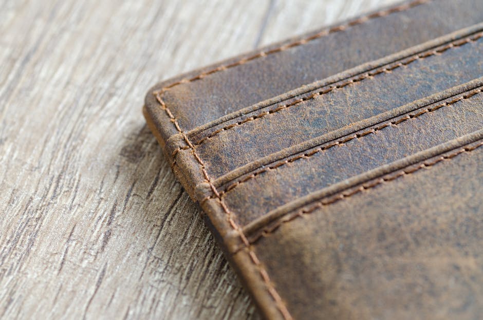 Close-up of elegant leather accessories on wooden surface