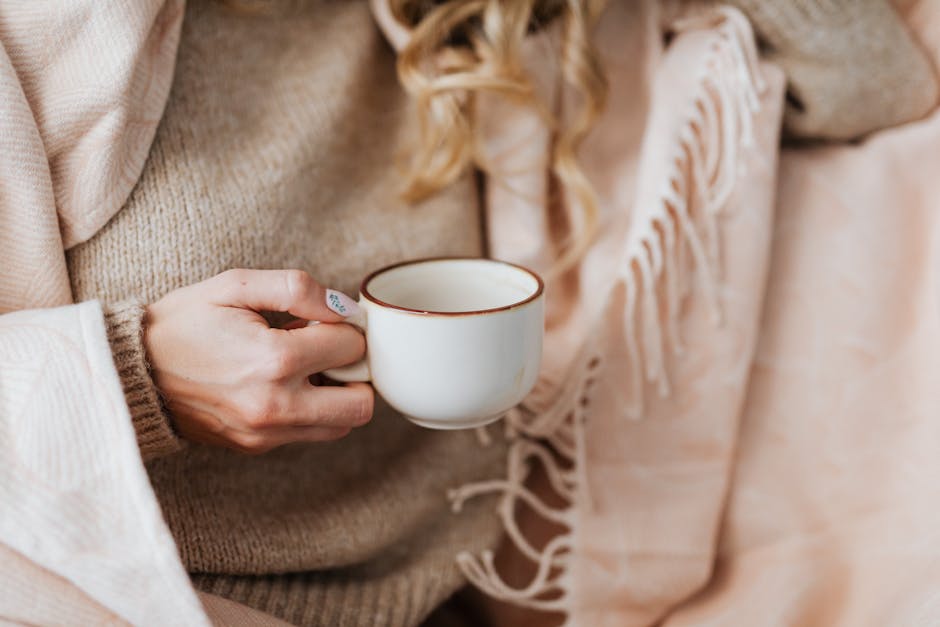 Close up of woman hands holding a warm cup