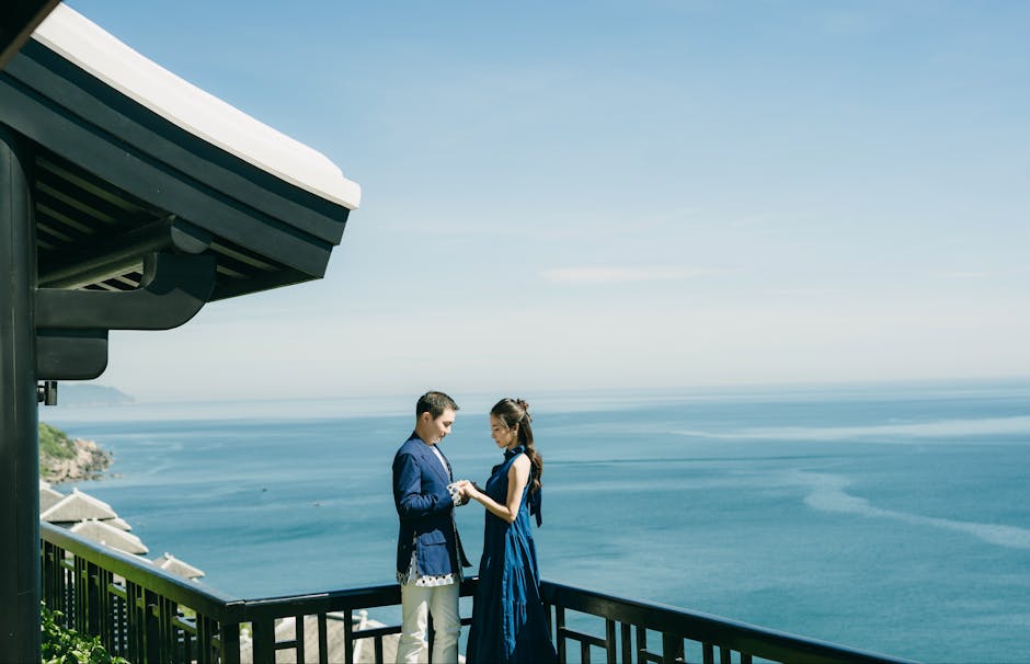 couple holding hands scenic coastline