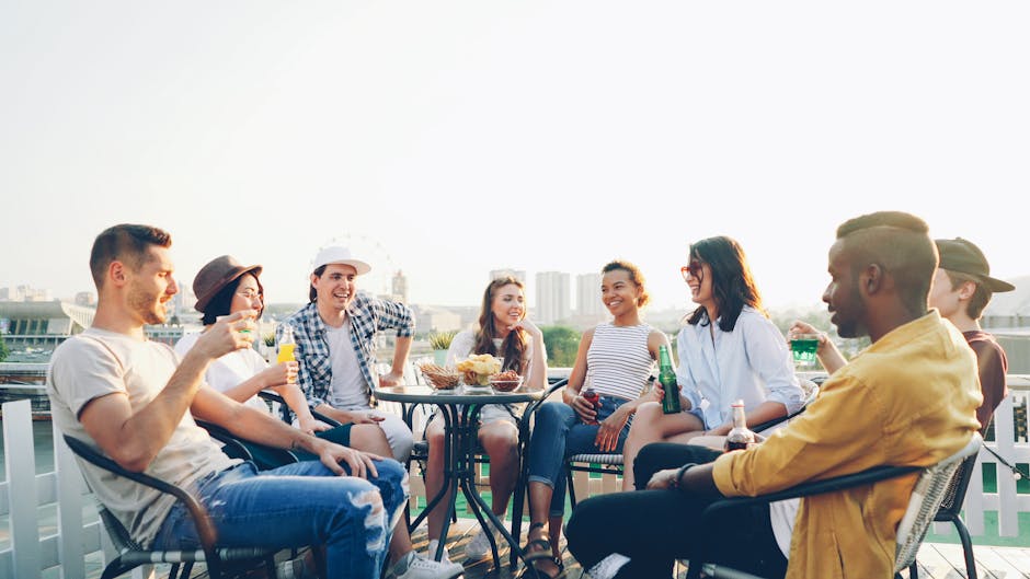 diverse group networking at a rooftop bar