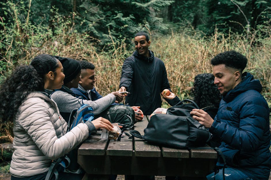 Diverse group of friends sharing a meal at outdoor table