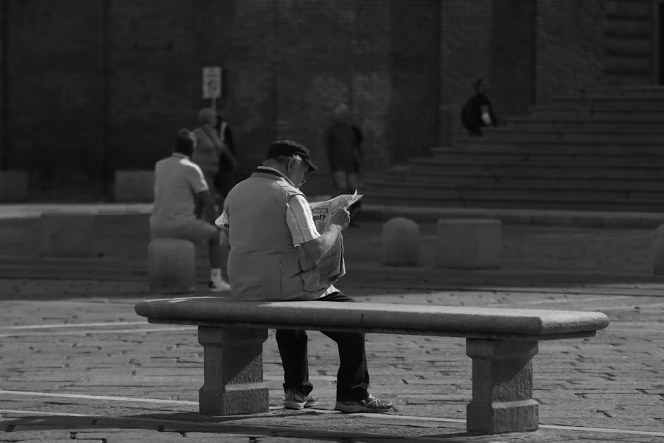 Elderly Italian man reading newspaper