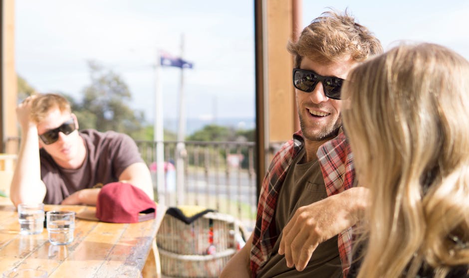 group of friends laughing at outdoor cafe