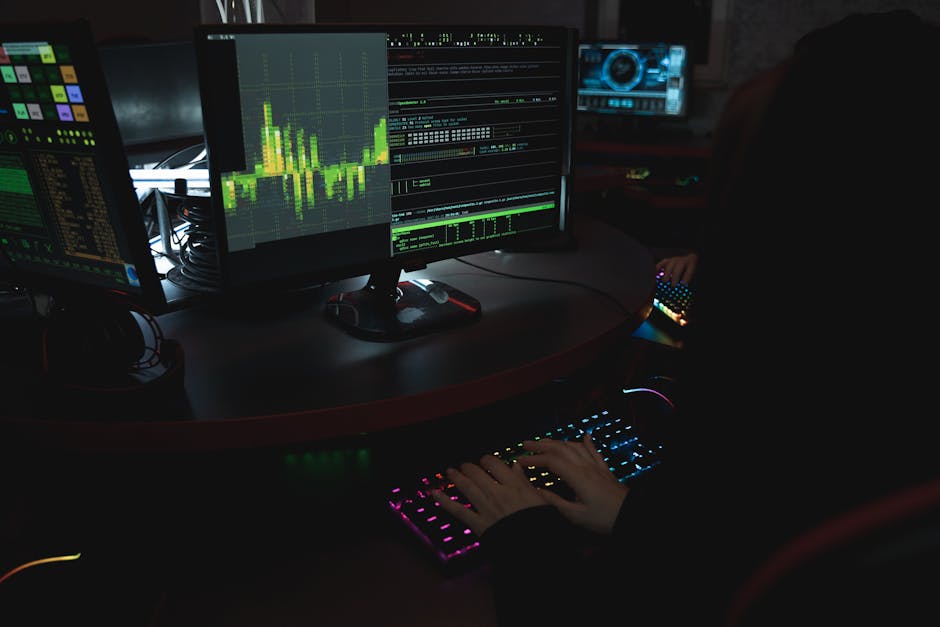 Hands coding on computer with data analysis graphs