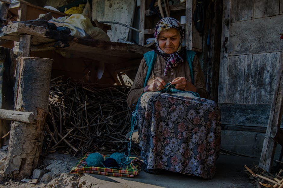 Old woman knitting by window with rustic background