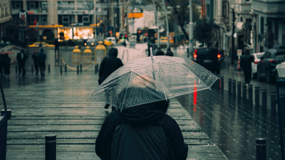 People walking with umbrellas in rainy Krakow