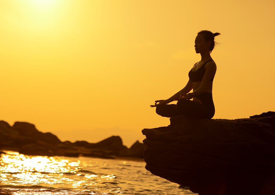 person meditating at sunset