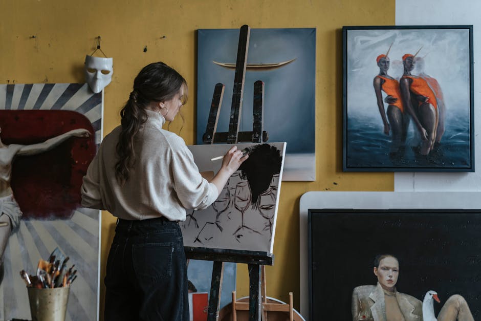 person painting on easel