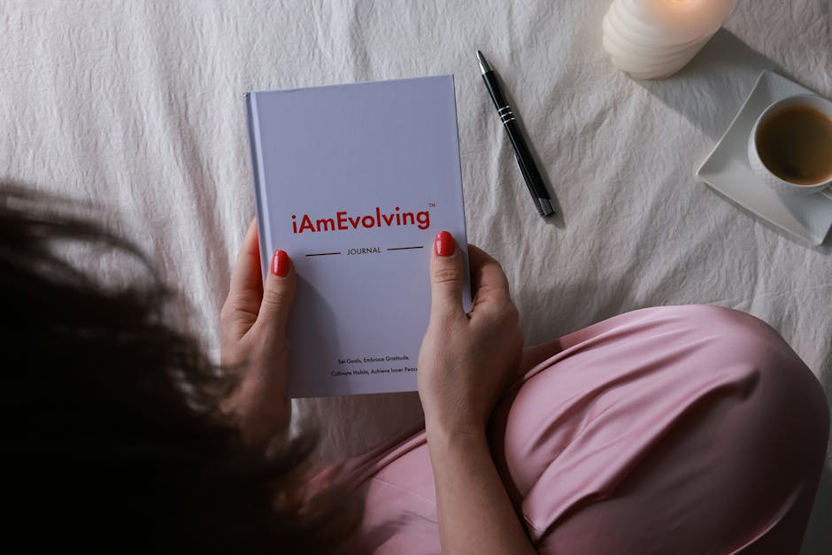 person writing in gratitude journal in cozy cafe