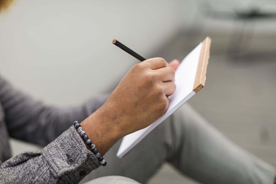 person writing in journal