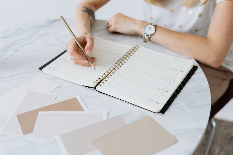 person writing planner desk