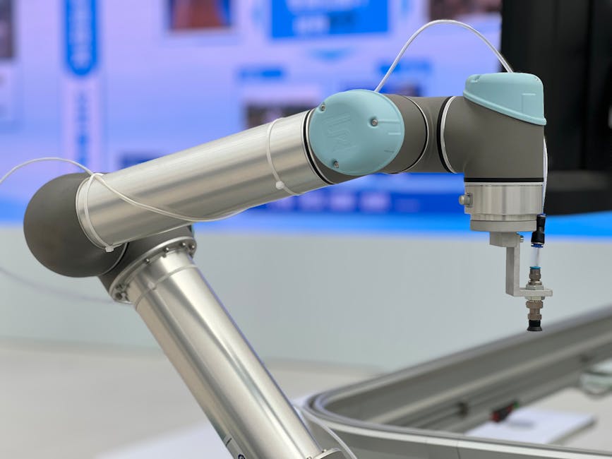 Robotic arm with human hand working together in factory
