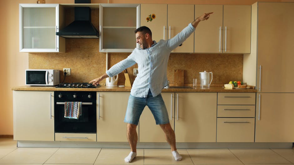smiling person dancing in kitchen
