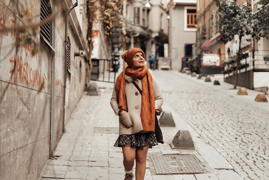 woman accessorizing with scarf and neutral handbag