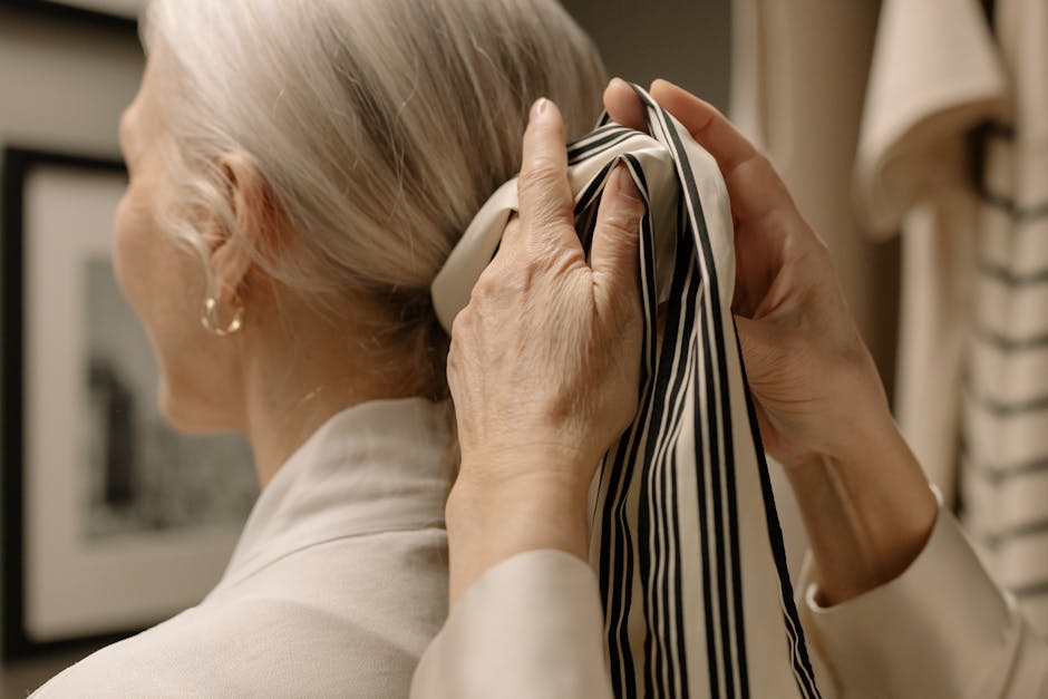 Woman arranging silk scarf outfit