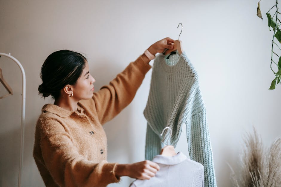 woman comparing two outfits in front of mirror