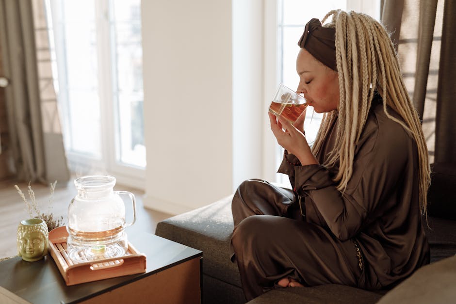 Woman drinking tea mindfully in a cozy setting