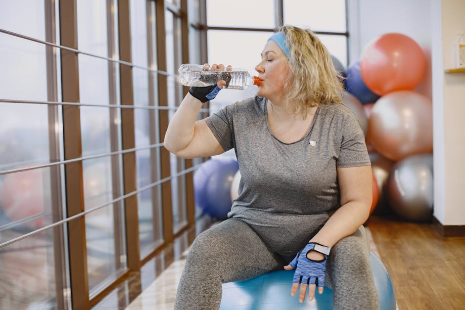 woman drinking water and stretching happily