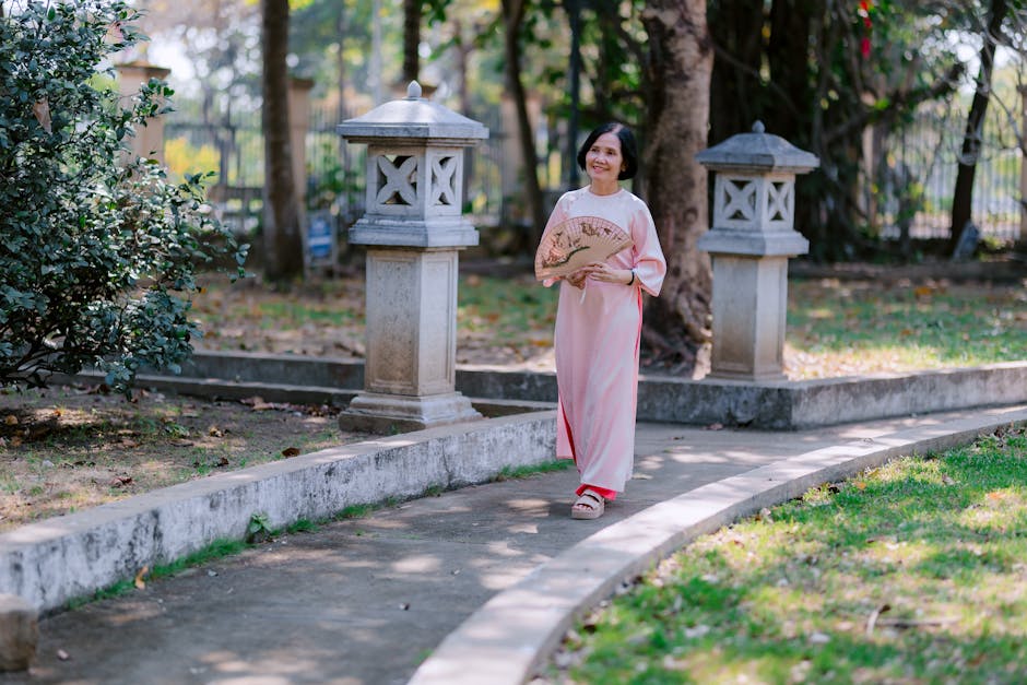 Woman enjoying a leisurely walk in a park with sunlight