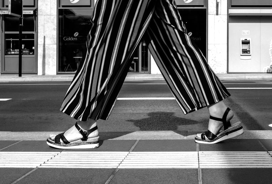 woman in wide leg pants walking city street
