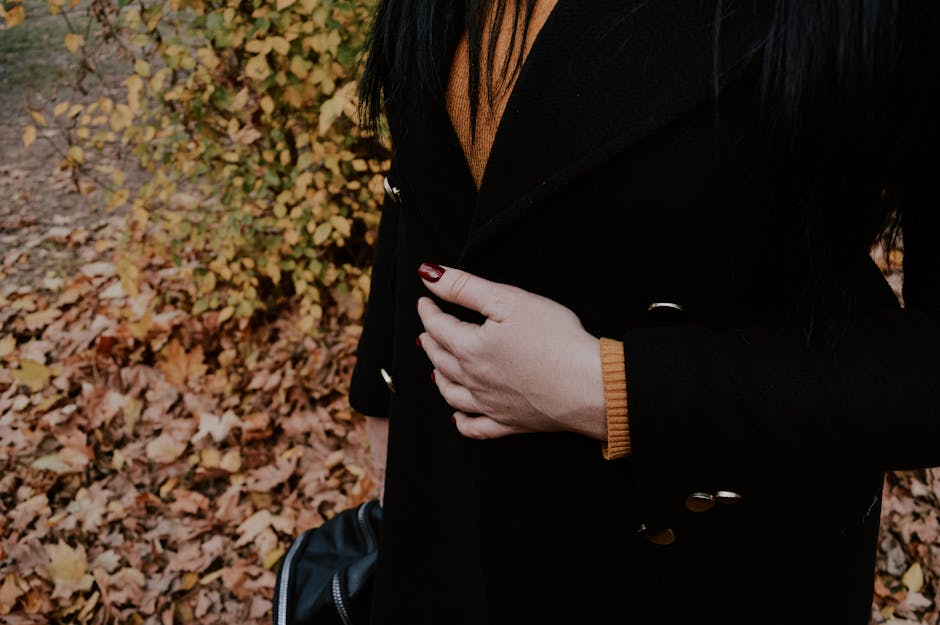 woman layering clothes for transitional weather