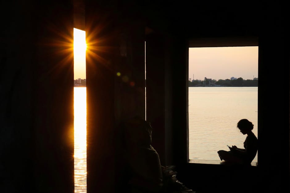 woman meditating by window sunrise