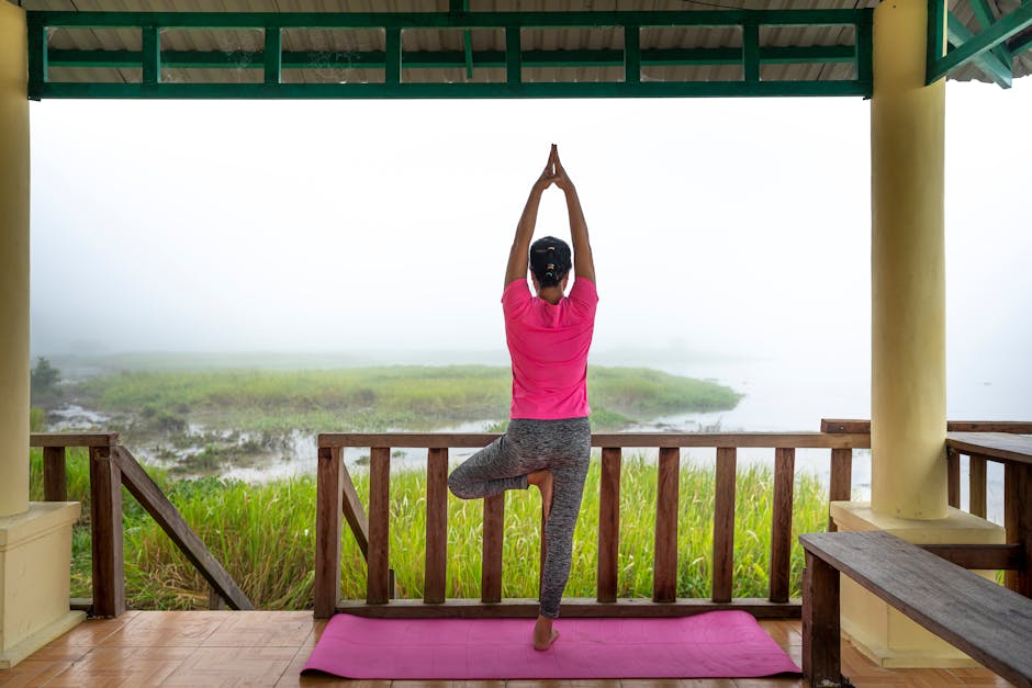 Woman practicing yoga with nature view