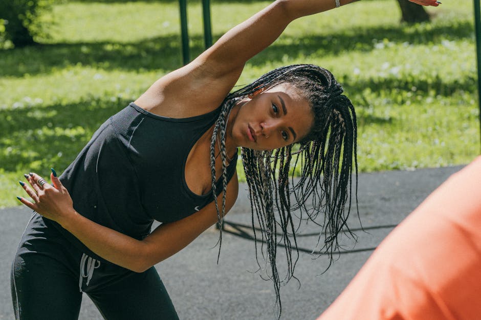 Woman stretching in sunny park