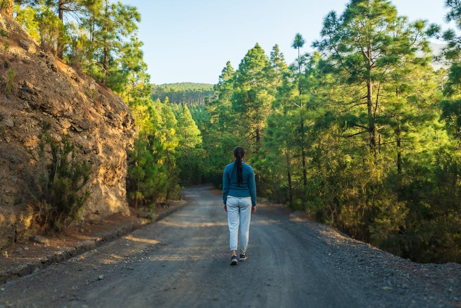 woman walking in a forest path