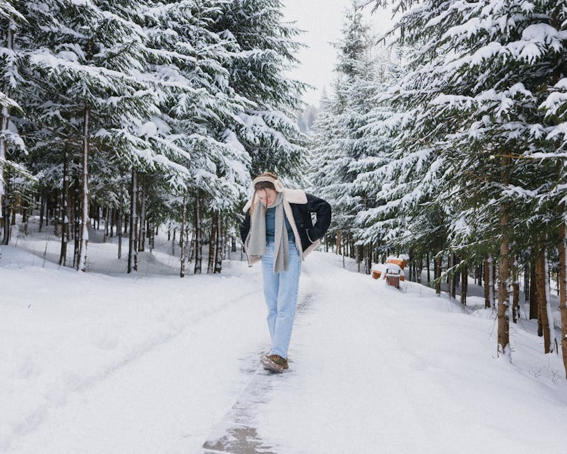 woman walking in snow in fashionable winter outfit