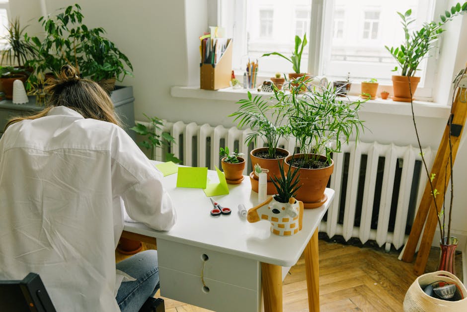 woman working calmly at desk with plants